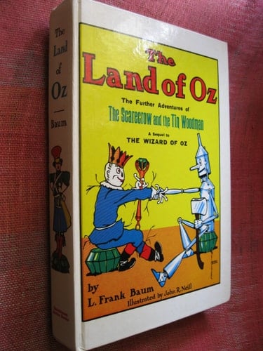 The Land of Oz Being an Account of the Further Adventures of the Scarecrow and Tin Woodman, and Also the Strange Experiences of the Highly Magnified Woggle-Bug, Jack Pumpkinhead, the Animated Saw-Horse and the Gump...